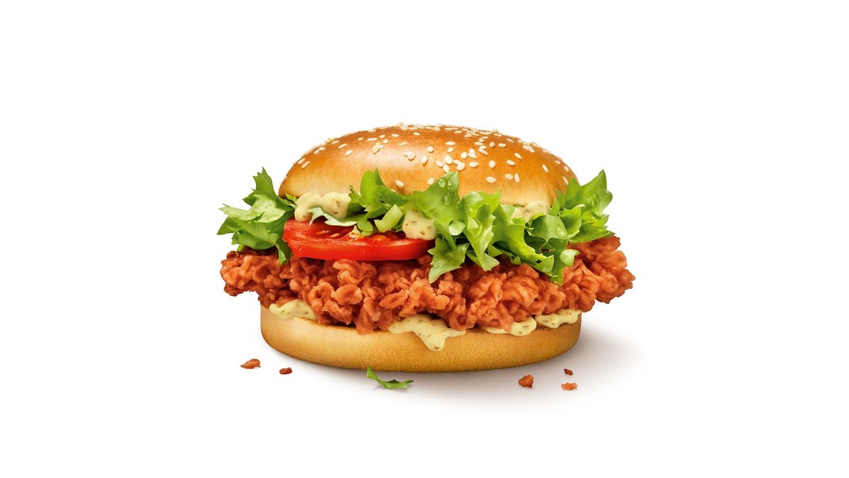 Officiële KFC-productfoto van de Zinger Burger met pittige kipfilet, sla en tomaat op een sesambroodje